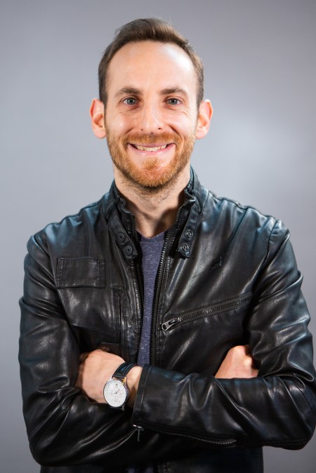 sam-alex-headshot-hi-rez-leather-coat-gray-back-2